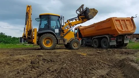 Roman, Romania, 07/7/2021: Loading Dump Truck With Top Soil  Using JCB, 4K Stock Footage 156812811