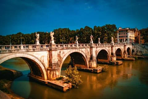 A Roman stone bridge lined with statues Stock Photos