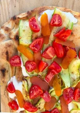 Roman-style flatbread with zucchini, cherry tomatoes and bottarga Stock Photos