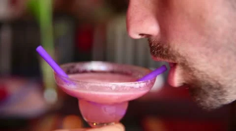 Romancic couple drinking cocktail from same glass at bar Stock Footage 12172440