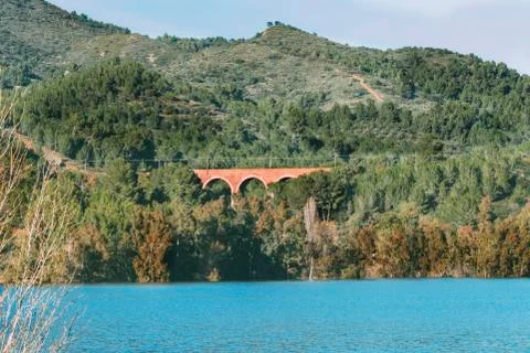 Romanesque bridge for the passage of train between the mountains. Stock Photos