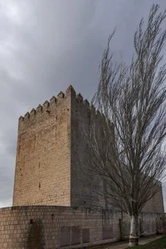 Romanesque castle and dramatic cloudy and stormy sky . Palencia, Spain Stock Photos