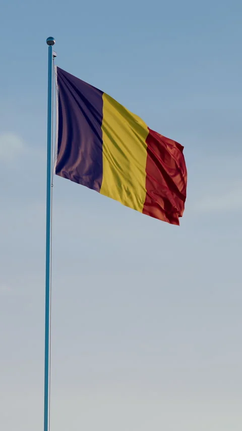 Romania, Bucharest: Cinematic Vertical Waving National Flag Against Blue Sky 스톡 동영상 322569062