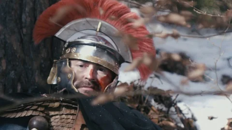 Romanian centurion in agony, with face full of blood, collapsed near the tru Stock Footage 125999664