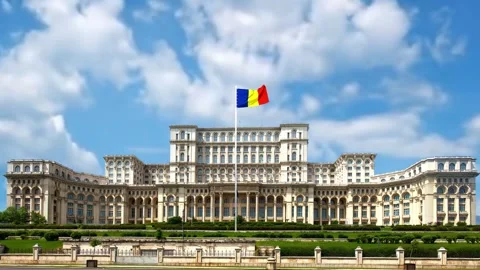 Romanian flag flying high above a massive government building motion video Stock Footage 345874537