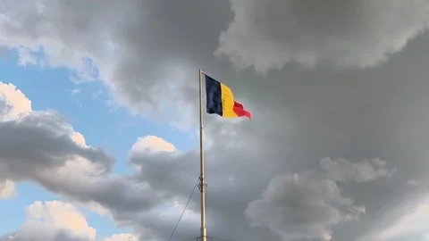 Romanian Flag Waving Against Dramatic Cloudy Sky Vídeos de archivo 313134651