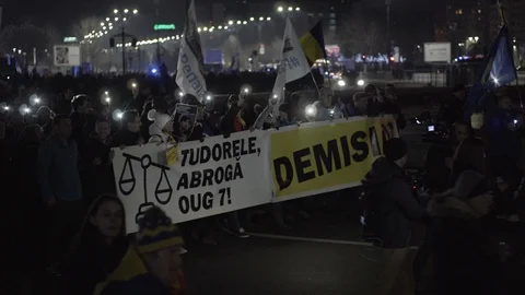 Romanians anti-corruption protest in Bucharest, march with phone lights on Stock Footage 104077052