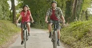 Romantic Active Couple Riding E-Bike Bicycles Mtb On A Beutiful Outdoor Woods Stock Footage