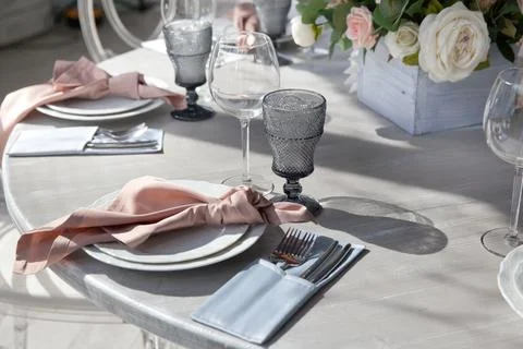 Romantic atmosphere in the cafe. Reserved table in the restaurant. Flowers an Stock Photos