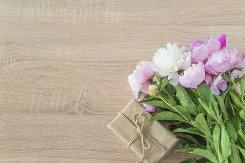 Romantic background with frame of white and white peonies flowers and handm.. Stock Photos