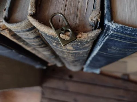 Romantic background. Lock with a heart on old books. Stock Photos