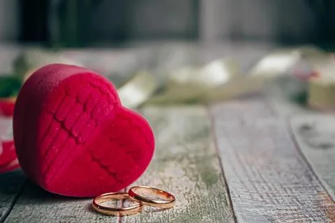 A romantic background for lovers, a box in the form of a heart and two rings Stock Photos