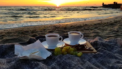 Romantic beach picnic with brie cheese and sweets at sunset. Vídeos de archivo 337180237