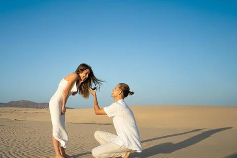 Romantic beach proposal at sunset Stock Photos