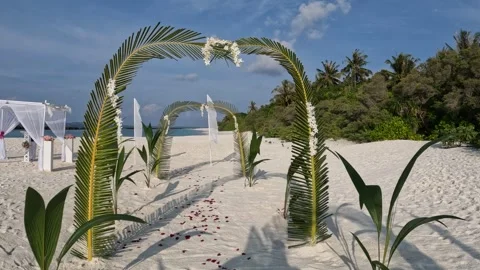A romantic beach wedding setup in the Maldives with palm arches and flowers Video stock 286104878