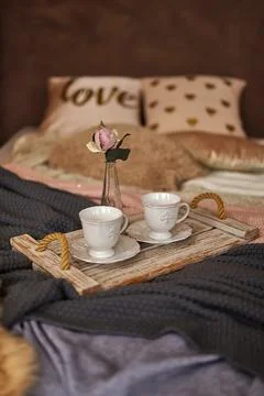 Romantic Bed with different warm blankets and pillows Stock Photos