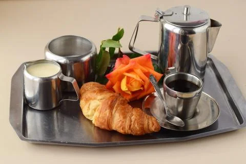 Romantic breakfast in bed. Coffee set, rose, crisp with egg on a silver tray. Stock Photos