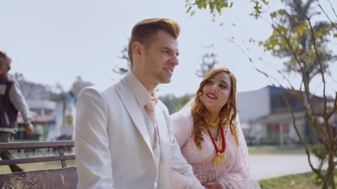 Romantic Bride on Bench by Phewa Lake, Groom in Background, Pokhara, Nepal Stock Footage 319913465