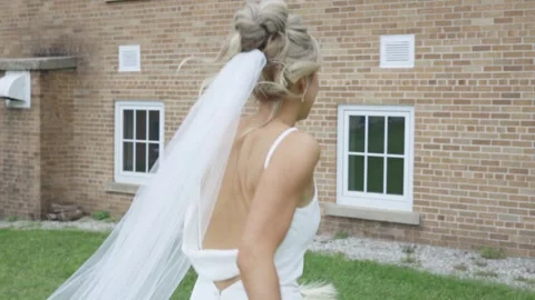 Romantic bride running through lush greenery Stock Footage 297459489