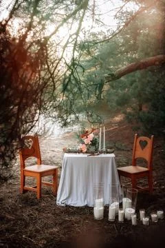 Romantic candlelit dinner in the autumn forest for lovers Stock Photos