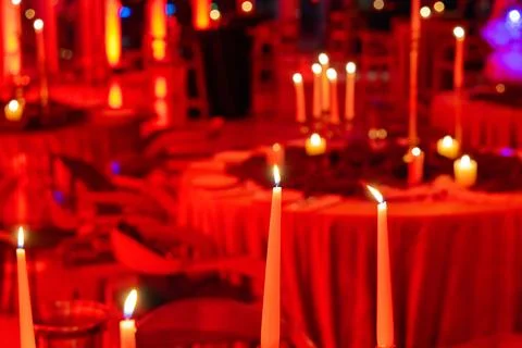 Romantic Candlelit Table Setup with Red Lighting Stock Photos