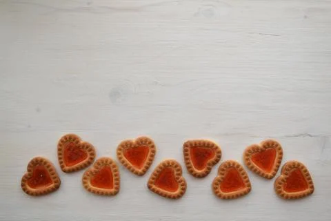 Romantic card with copyspace. Rustic white background with cookie hearts Stock Photos