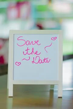 Romantic Chalkboard with Save the Date Message and Handwritten Hearts Stock Photos