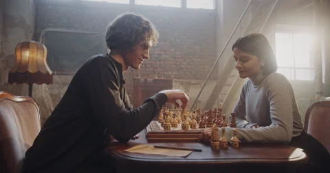 Romantic Chess Game Between Young Man and Woman in a Vintage Setting with Warm Stock-Footage 299545001