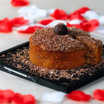 Romantic chocolate walnut cake with slice on the side Stock Photos