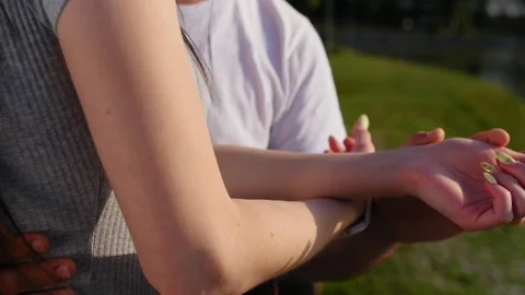 Romantic closeup of a young man s hand holding a young woman s hand when the Stock Footage 116669990