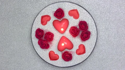 Romantic composition of burning candles and roses on a silvery surface Stock Footage 168675657