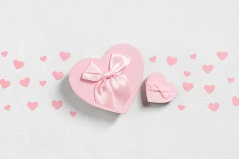Romantic composition with pink gift boxes in the shape of hearts Stock Photos