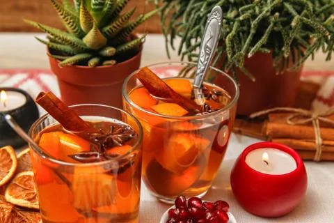 Romantic composition with two cups of tea with orange, anise and cinnamon Stock Photos