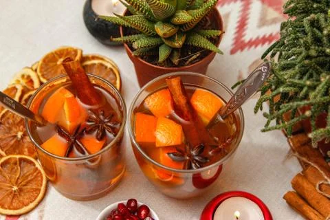 Romantic composition with two cups of tea with orange, anise and cinnamon Stock Photos