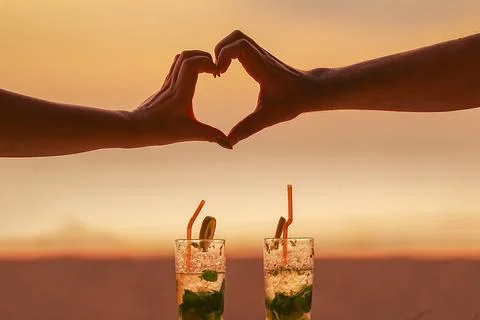 A romantic concept. two Lovers form the shape of a heart with their hands, .. Stock Photos