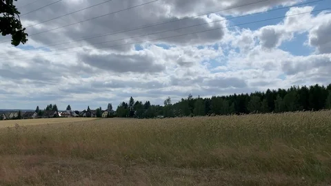 Romantic cornfield with village in the background Stock Footage 112026175