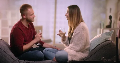 Romantic couple on couch flirting Video stock 77408618
