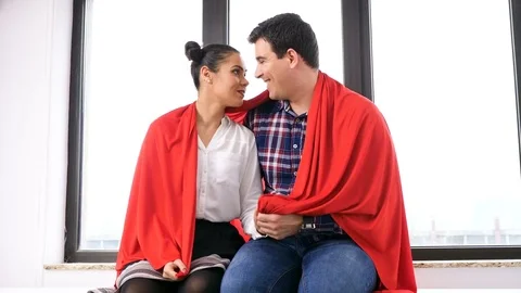 Romantic couple covered with a blanket next to a big window Video stock 84893536