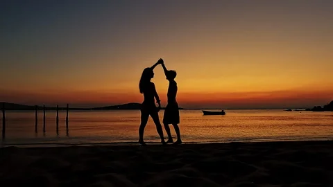 Romantic Couple Dancing and Twirling at Sunset Beach Silhouette Video stock 335522269