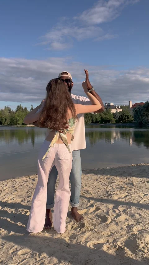 Romantic couple dancing bachata together by lake on summer day. Man and woman Stock Footage 328591475