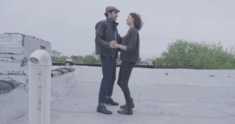 Romantic Couple Dancing Casually On Roof Stock Footage 94446331