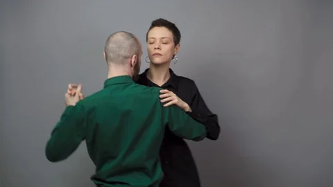 Romantic couple dancing on gray background. Man and woman are dancing slow blues Video stock 124431937