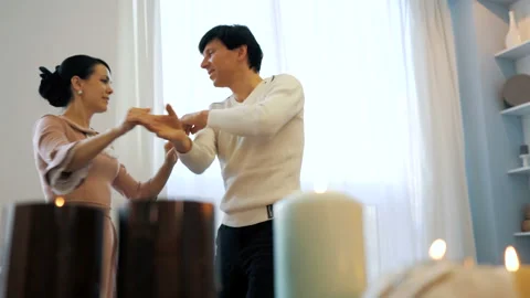 Romantic couple dancing by the window Stock Footage 103422958