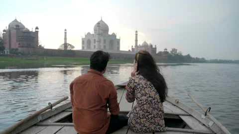 A romantic couple is on a date sitting and talking on wooden boat Stock Footage 139941686