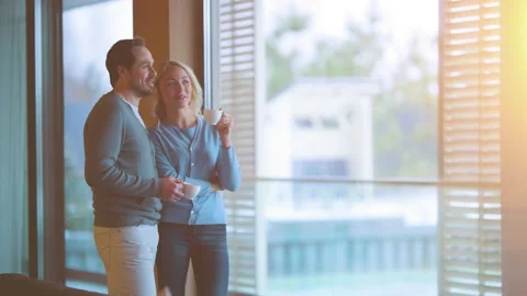 The romantic couple drinking coffee at the window and talking. slow motion Stock Footage 167734741