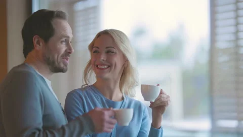 The romantic couple drinking coffee at the window and talking. slow motion Stock Footage 167734879