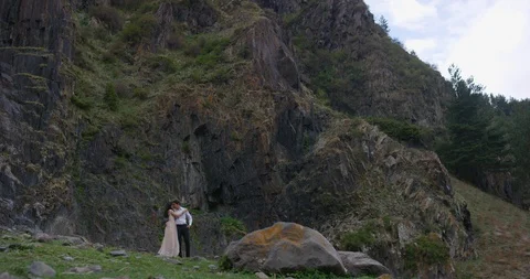 Romantic couple embraces on the edge of the mountain Stock Footage 96645294