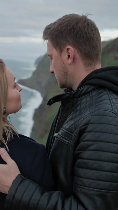 Romantic couple embracing on a cliff overlooking the ocean Stock Footage 327035345
