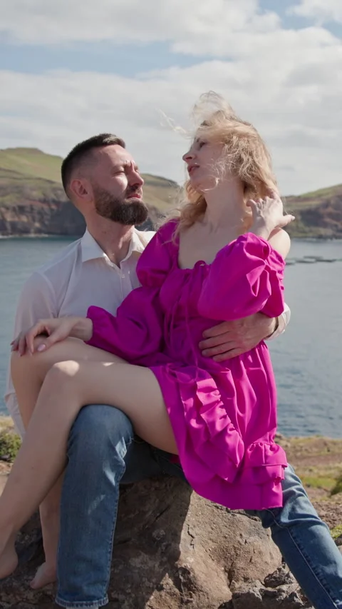 Romantic couple embracing on cliff overlooking ocean in madeira Stock Footage 327041617