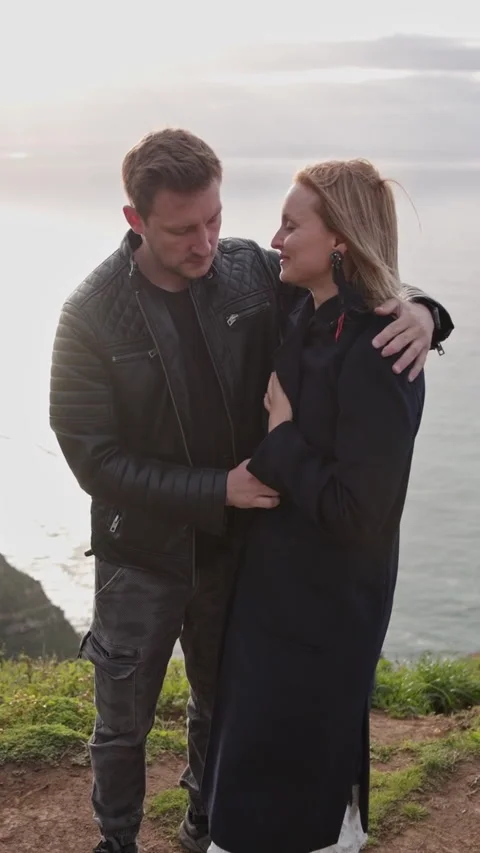 Romantic couple embracing on cliff at sunset Stock Footage 327035039